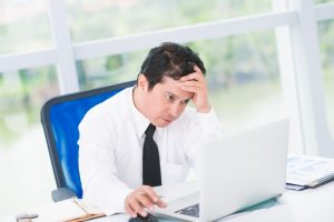 frustrated man using laptop