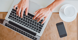 woman typing on laptop