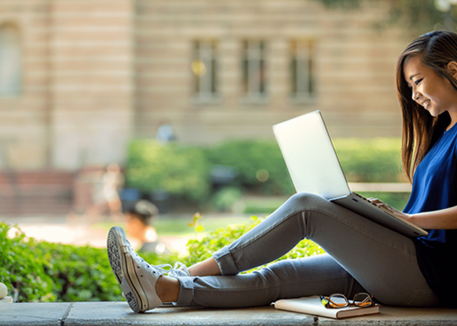 girl using laptop at college