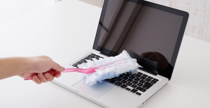 woman dusting laptop