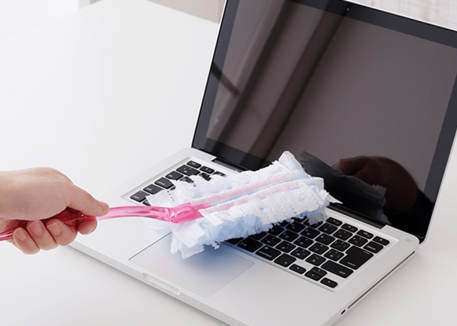 woman dusting laptop