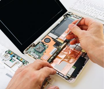 man repairing insides of laptop