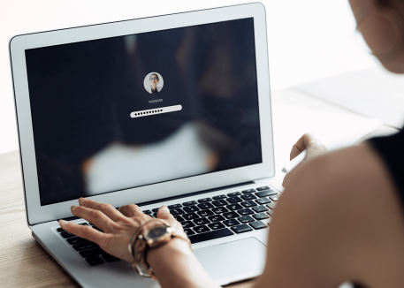 woman using password best practices on laptop