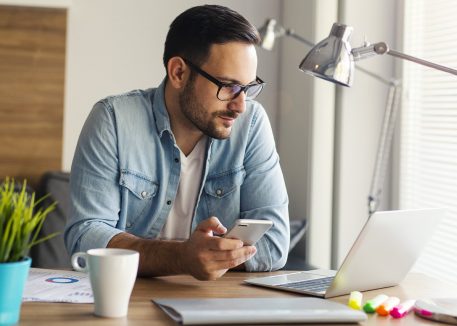 man works remotely in a home office