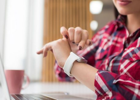 woman copies security code from her Apple Watch onto her MacBook