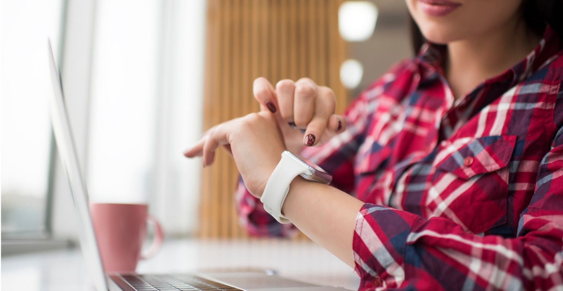 woman copies security code from her Apple Watch onto her MacBook