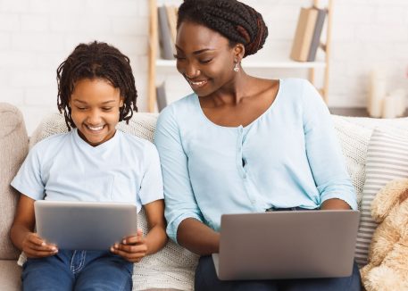 mom goes over school work with son on his tablet