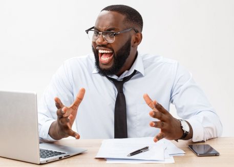 frustrated man using his laptop