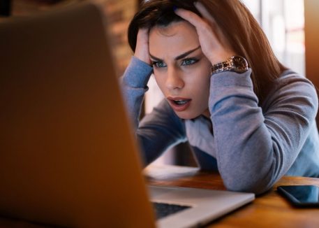 frustrated woman wondering why her computer is crashing on a regular basis