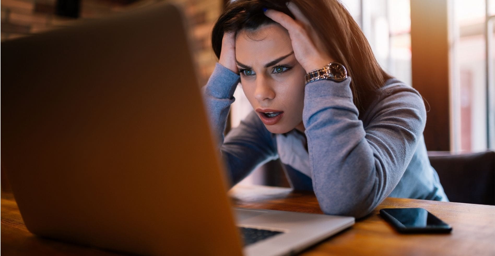 frustrated woman wondering why her computer is crashing on a regular basis