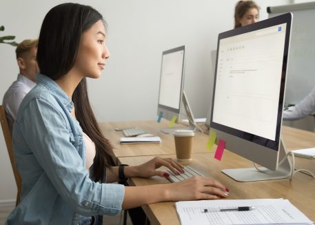 woman in office using computer keyboard