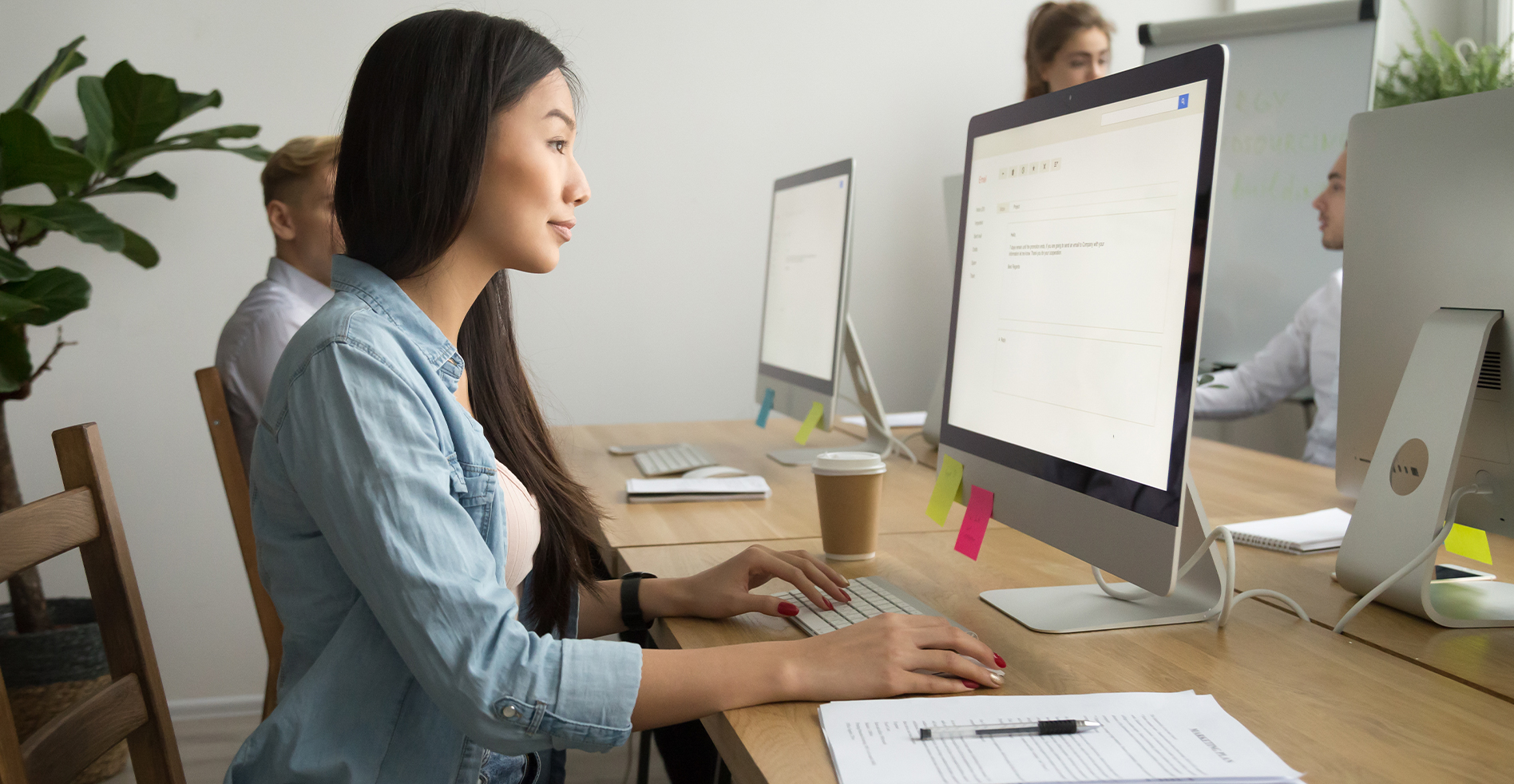 woman in office using computer keyboard