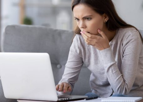 woman trying to determine if laptop is experiencing motherboard failure