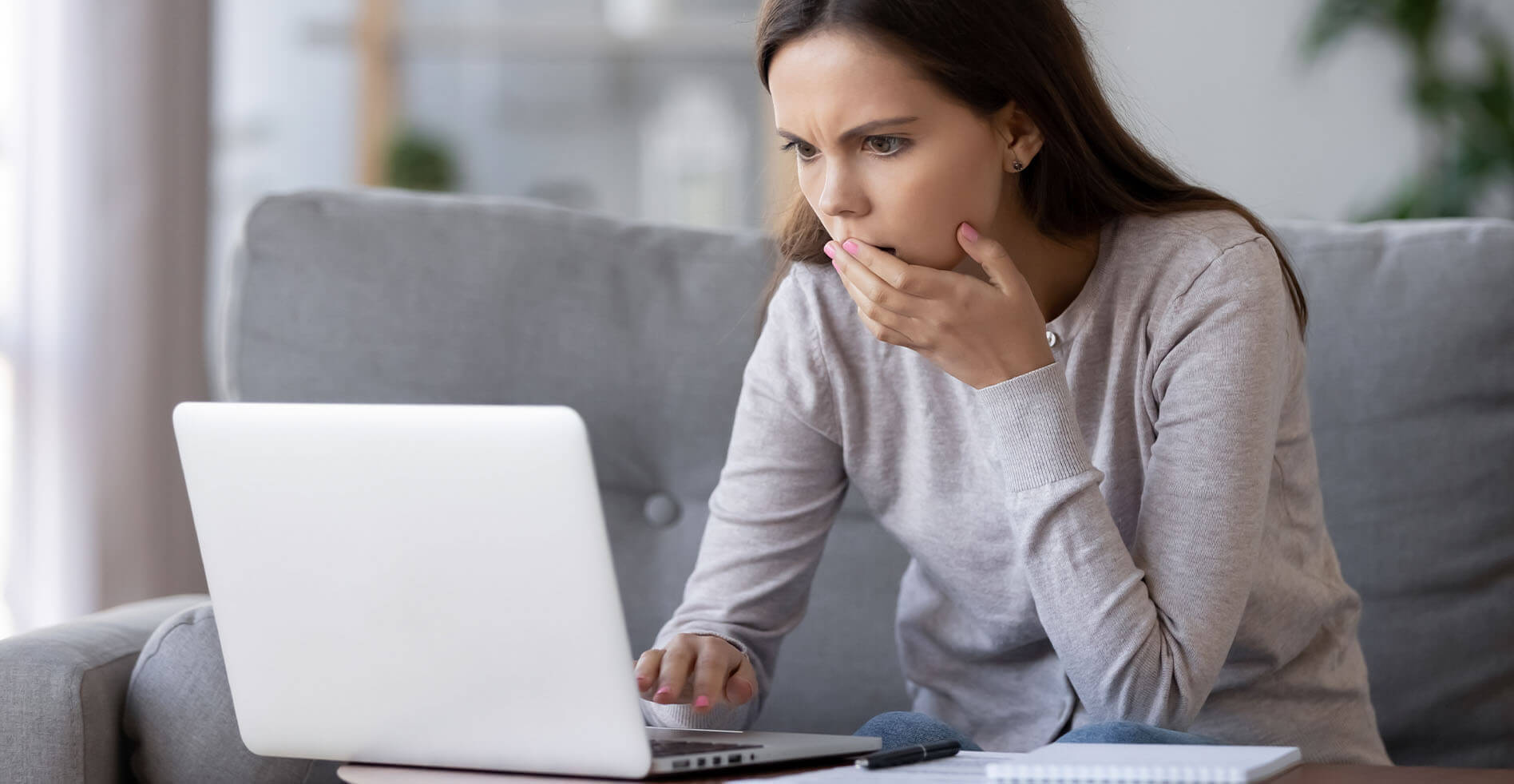 woman trying to determine if laptop is experiencing motherboard failure