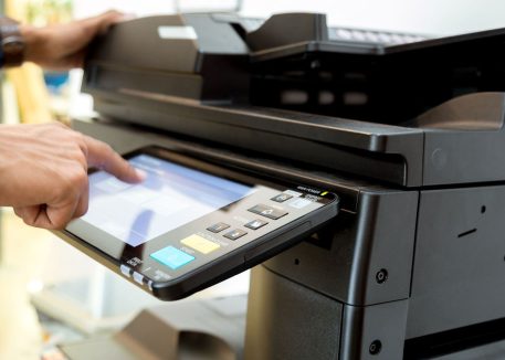 a man using a printer in an office