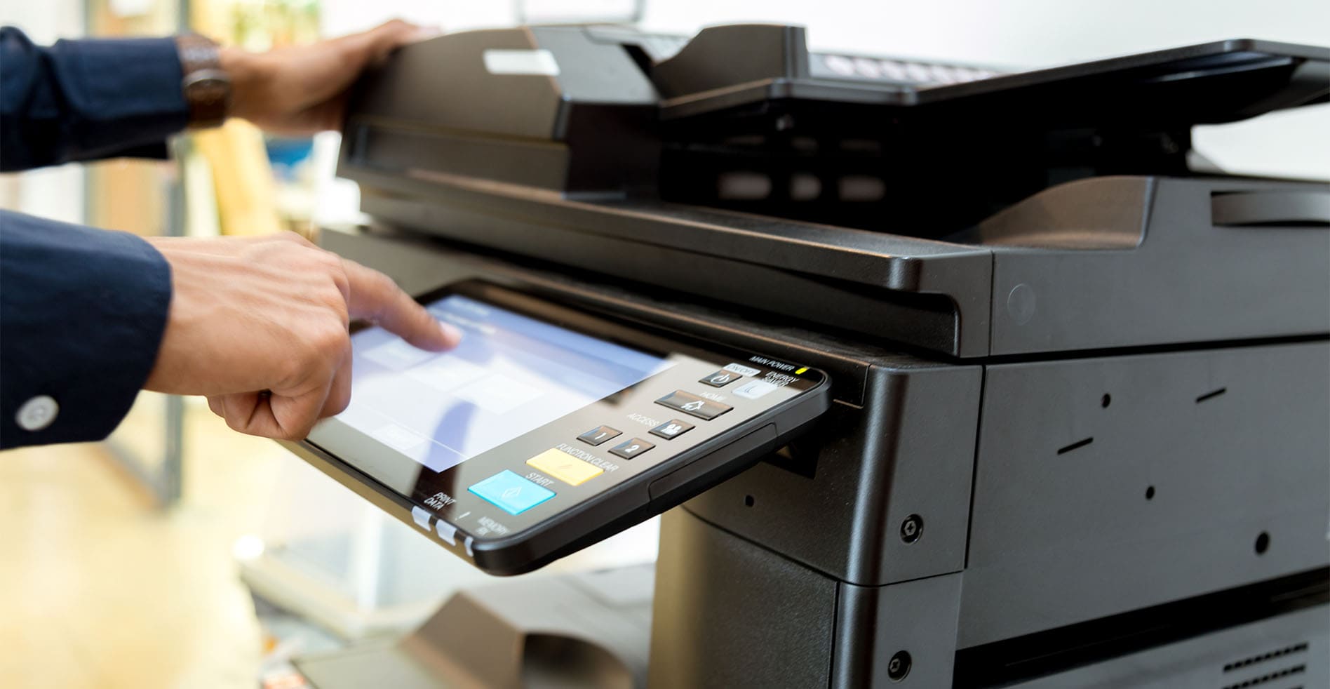 a man using a printer in an office